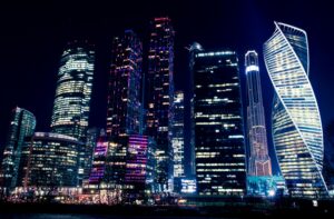 About Illuminated night view of Moscow's modern skyscrapers, showcasing vibrant city lights and urban architecture.